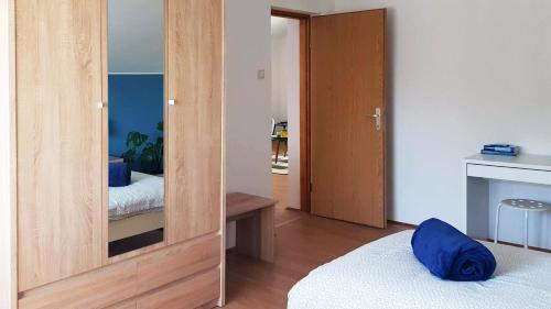 a room with a mirror and a bedroom with a bed at Apartman 13 in Križevci