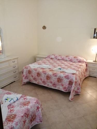 a bedroom with two beds and a dresser and a bed sidx sidx sidx sidx at FMR Oplonti PLINIO BEB in Torre Annunziata