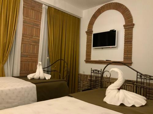a hotel room with two beds and a mirror at Janashia Hotels in Tbilisi City