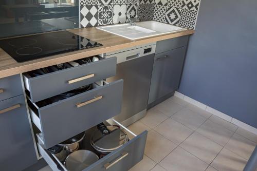 a kitchen with a sink and a counter at Paisible Maison entière 140m2 avec véranda vue sur la campagne in Renwez