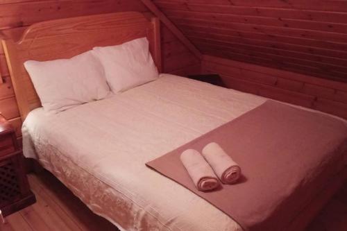 a bedroom with a bed with two towels on it at Chalet 52, Serra da Estrela a perder de vista in Penhas da Saúde