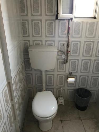 a bathroom with a white toilet in a room at Factory in Athens