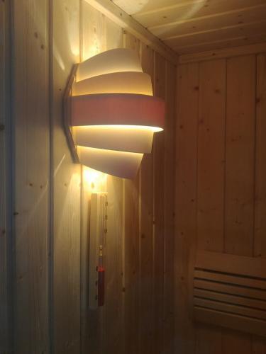 a light fixture on the wall of a room at Apartman Arena in Štrigova