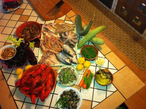 a table with many different types of seafood and vegetables at Villa Carla in Petacciato