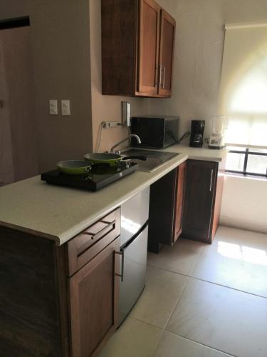 a kitchen with a sink and a counter top at KIA - PESQUERIA - AEROPUERTO MONTERREY a in Monterrey