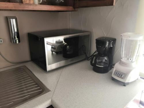 a microwave sitting on a counter next to a blender at KIA - PESQUERIA - AEROPUERTO MONTERREY a in Monterrey