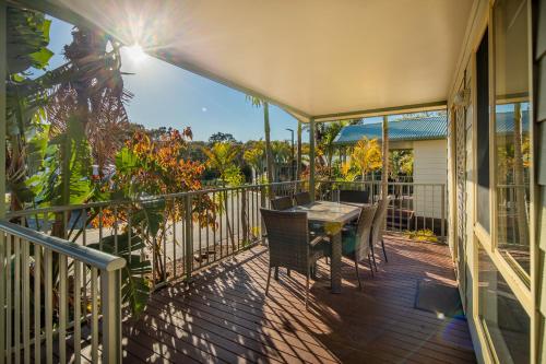 a balcony with a table and chairs on a house at Ingenia Holidays One Mile Beach in One Mile