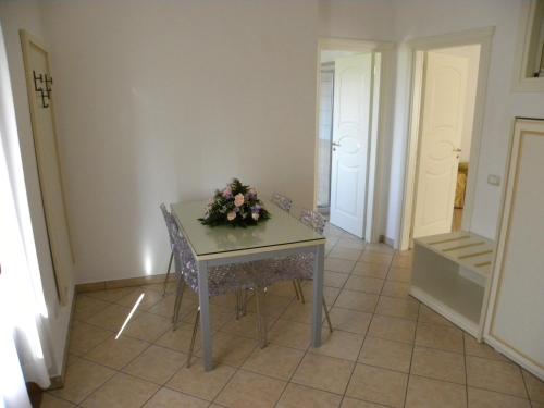 a table with flowers on it in a room at Hotel Ristorante Borgo La Tana in Maratea