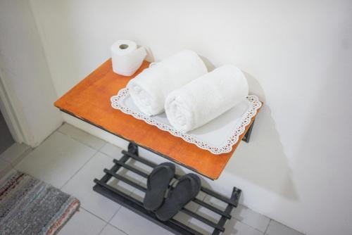 a table with towels and toilet paper on it at Ozzy Lodge Semporna in Semporna