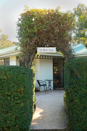 a white house with a sign that reads the white house at Home Farm Healesville in Healesville