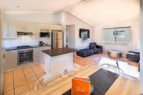a kitchen and living room with a table and chairs at Ingenia Holidays One Mile Beach in One Mile