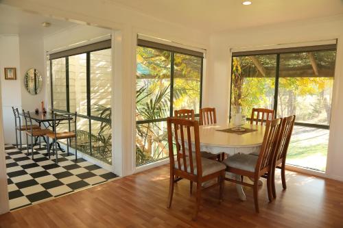 a dining room with a table and chairs at Home Farm Healesville in Healesville