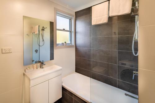 a bathroom with a shower and a sink at Ingenia Holidays One Mile Beach in One Mile