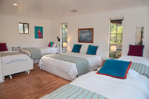 a room with three beds in a room at Home Farm Healesville in Healesville