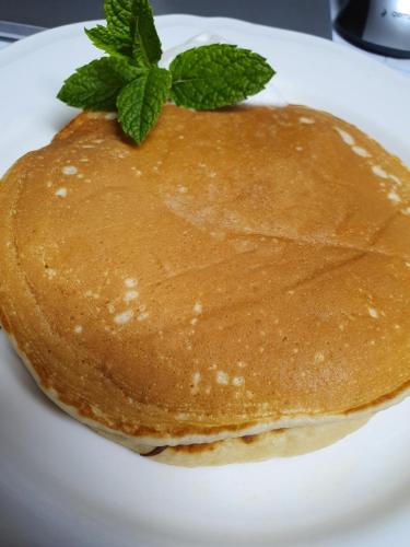a pancake with a sprig of mint on a plate at Chata nad Sztolnią in Bystrzyca Górna