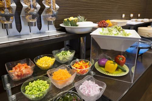 a buffet line with bowls of vegetables and other ingrediants at Shizutetsu Hotel Prezio Shizuoka Ekinan in Shizuoka