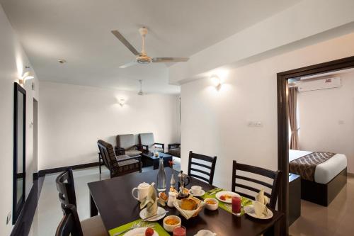 a dining room and living room with a table and chairs at Sterling Thekkady in Thekkady