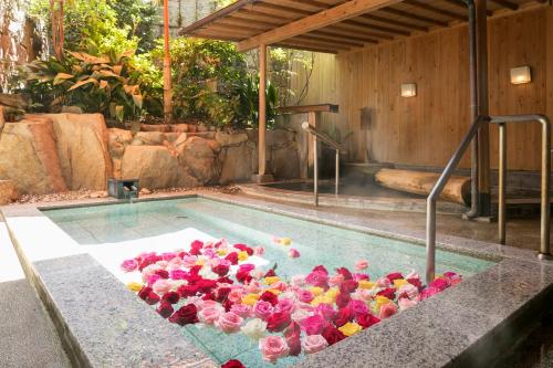 a bunch of flowers in a swimming pool at Yumoto Konpira Onsen Hananoyu Kobaitei in Kotohira