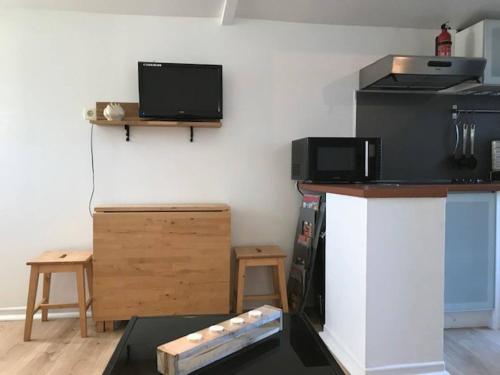 Il comprend une cuisine avec un comptoir, un four micro-ondes et une télévision. dans l'établissement Studio indépendant près cap canaille avec terrasse, à La Ciotat