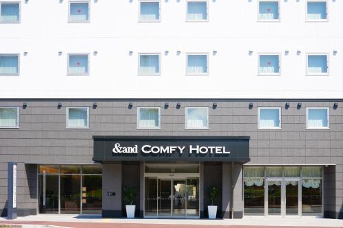 a building with a sign for a hotel at &and COMFY HOTEL Kumamoto Jo View in Kumamoto