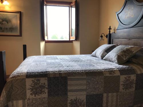 a bedroom with a bed with a quilt on it at La Riera in Vic