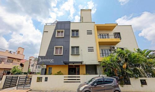 a building with a car parked in front of it at Itsy By Treebo - Jasmine in Mysore