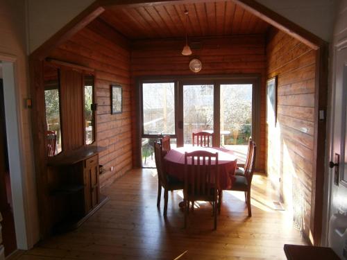 a dining room with a table and chairs in a house at Hurdit in Portland