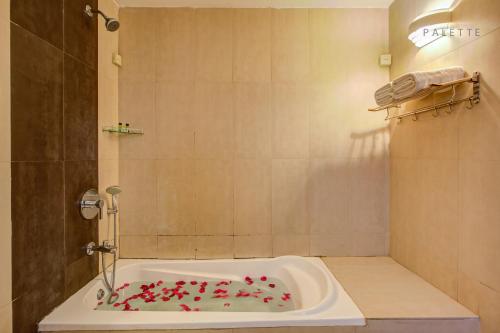 a bath tub filled with lots of pink sprinkles at Raj Residency in Hosdrug