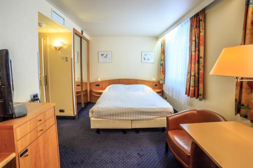 a hospital room with a bed and a table at Hotel Pacific in Ostend