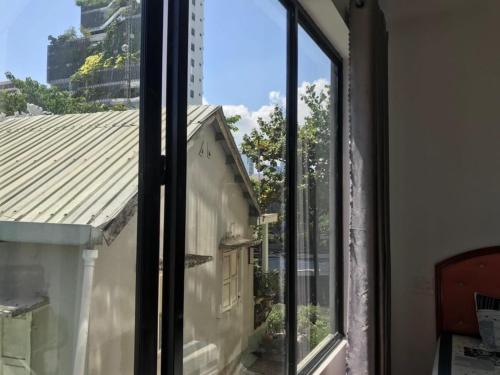 a window with a view of a building at Tam Homestay in Da Nang