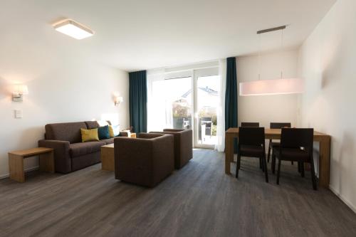 a living room with a couch and a table at Boardinghouse E68 in Schliengen