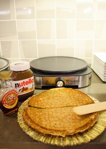 a pancake sitting on top of a counter with a pie at Mercure Toulouse Centre Wilson Capitole in Toulouse