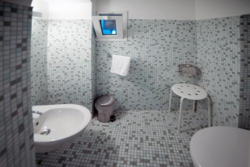 a bathroom with a sink and a toilet at B&B Al Duomo Molfetta in Molfetta