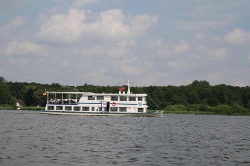 a white boat in the water on a lake at Marina View in Bad Zwischenahn