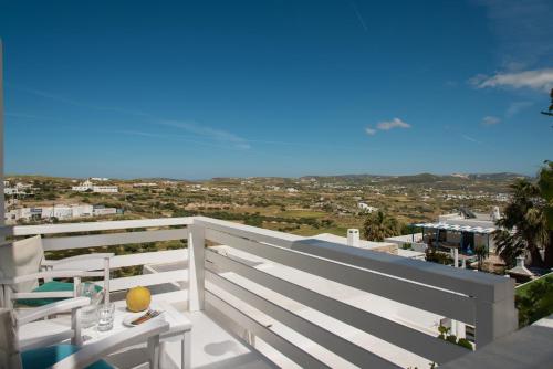 a white balcony with a table and chairs on it at Alexandros Village in Adamas