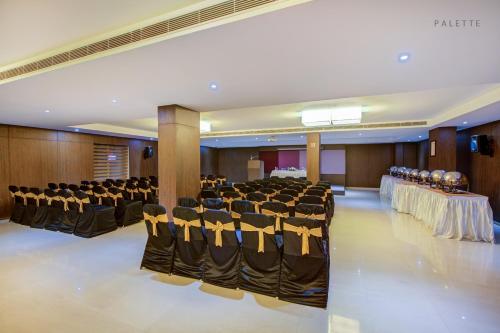 a banquet hall with rows of chairs and tables at JK Residency Kelakam in Kelakam
