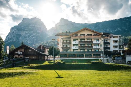 a large building in front of a mountain at Hotel Antines in La Villa
