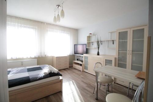 a bedroom with a bed and a table with chairs at 01 Gdynia Centrum - Apartament Mieszkanie dla 2 os in Gdynia