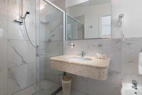 a bathroom with a sink and a shower at Hotel Villaggio Stromboli in Santa Domenica