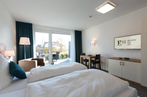 a hotel room with two beds and a window at Boardinghouse E68 in Schliengen