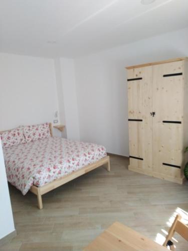 a bedroom with a bed and a wooden cabinet at Cristallo di neve b&b in Roccaraso