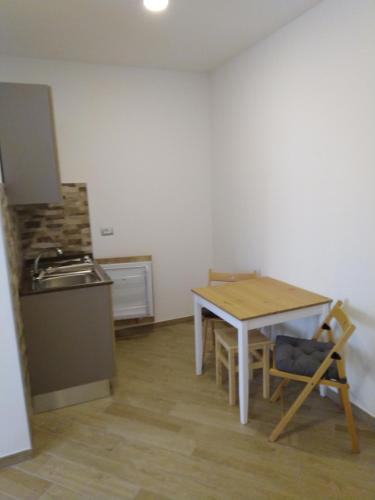 a small kitchen with a table and a stove at Cristallo di neve b&b in Roccaraso