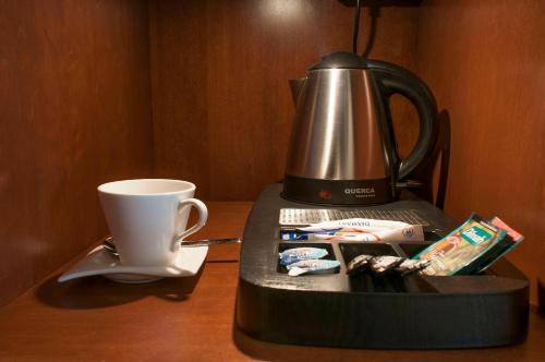 a coffee maker and a cup on a table at Hotel Splendor in Babice Nowe