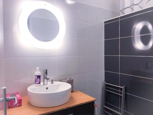 a bathroom with a white sink and a mirror at Boost Your Immo Les Deux Alpes Les Cimes 172 in Les Deux Alpes