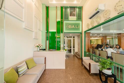 a restaurant with couches and people sitting at a table at Bali Hotel in Ho Chi Minh City