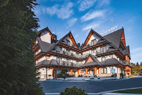 a hotel with a large building with balconies at Grand Tatry in Białka Tatrzańska