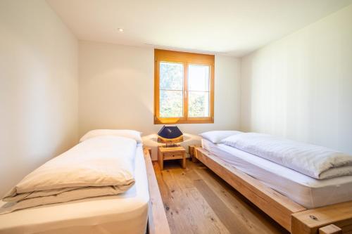 Postel nebo postele na pokoji v ubytování LAAX Homes - Taviarna Laax 3,6