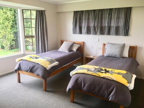 A bed or beds in a room at Waitomo Golf Ridge