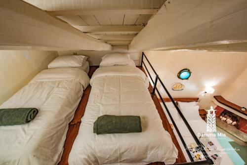 a couple of beds in a small room at Damma Mia in Damouchari