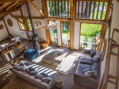 an overhead view of a living room with couches and windows at Ferme Liberté - stunning, comfortable, & modern sleeps 14- private mini van in Les Gets
